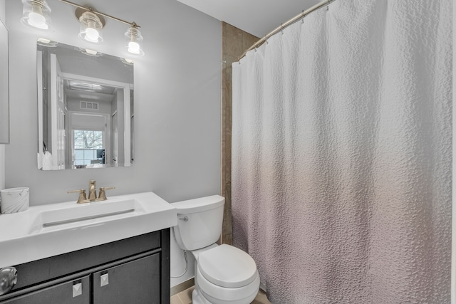 bathroom featuring a shower with curtain, visible vents, vanity, and toilet