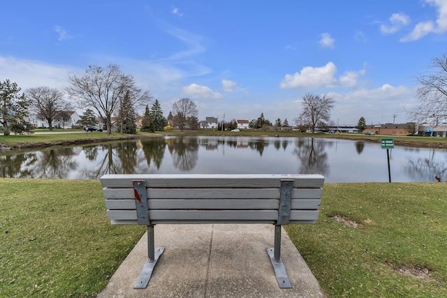 surrounding community featuring a lawn and a water view