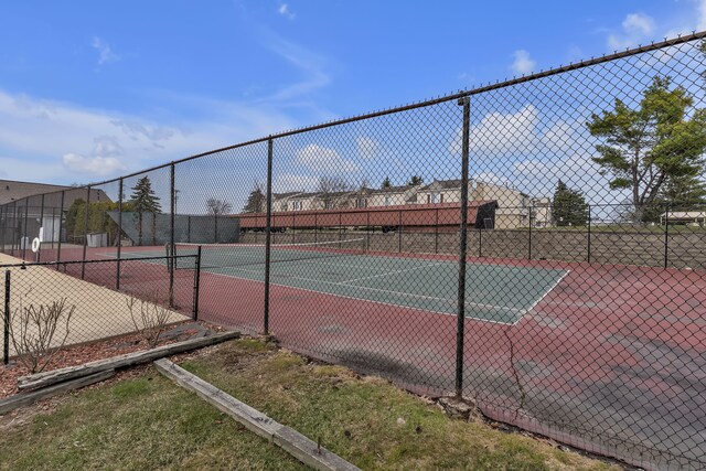 view of tennis court featuring fence