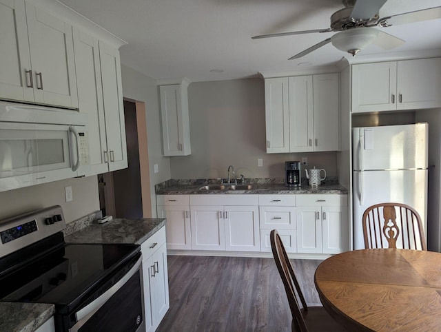 kitchen with white cabinets, a ceiling fan, a sink, dark wood-type flooring, and white appliances