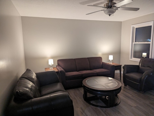 living room featuring dark wood-style floors and ceiling fan