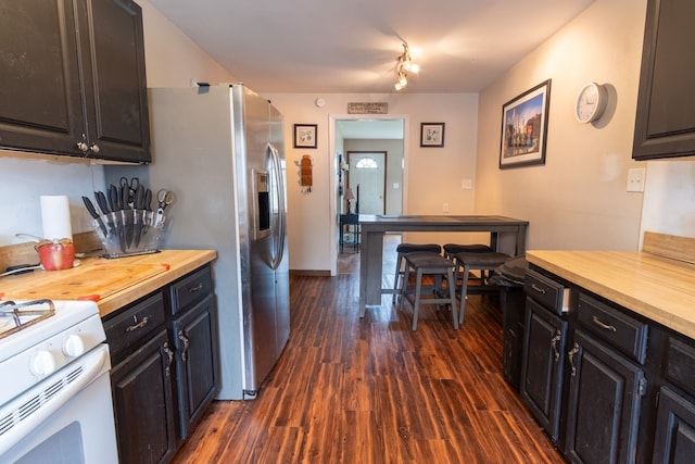 kitchen featuring white range with gas stovetop, wood counters, dark cabinetry, baseboards, and dark wood-style floors