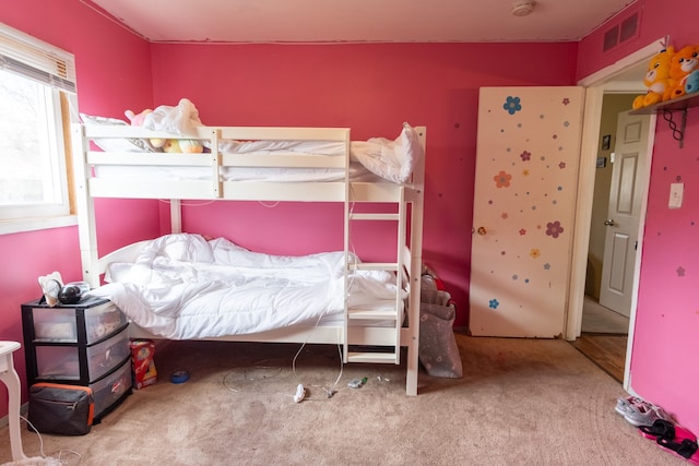 bedroom featuring carpet flooring and visible vents