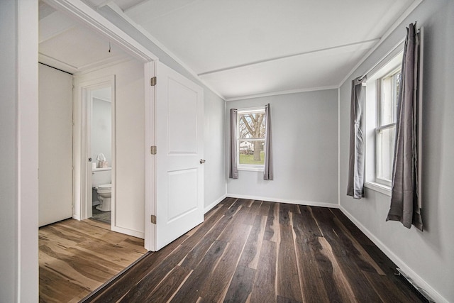 empty room with baseboards and wood finished floors