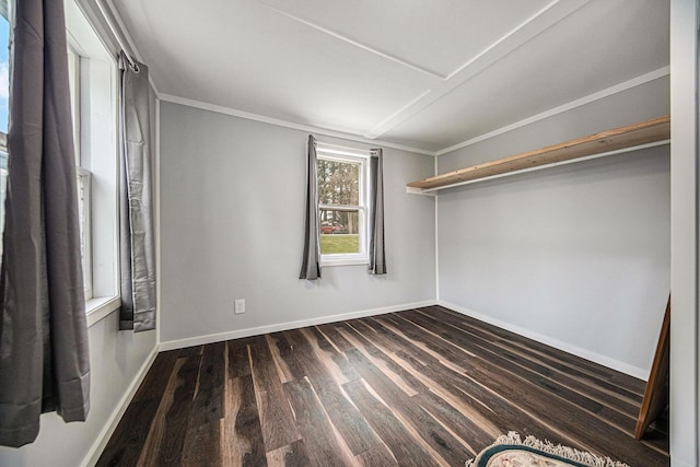 unfurnished bedroom with ornamental molding, baseboards, and dark wood-style flooring