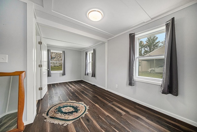 unfurnished room with wood finished floors and baseboards