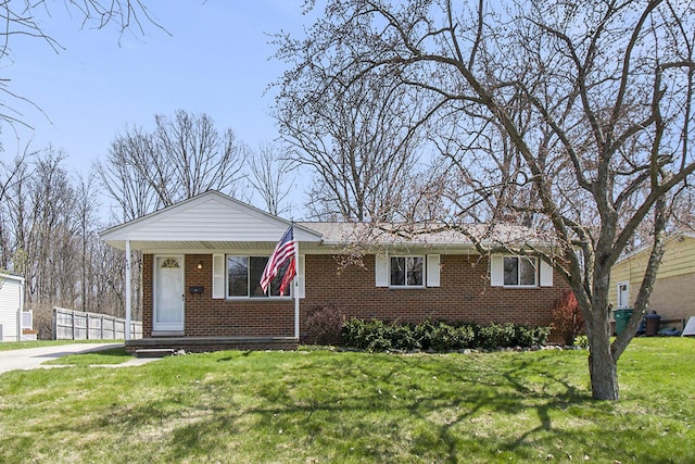 single story home with brick siding and a front yard