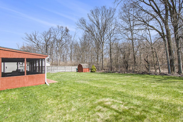 view of yard featuring an outbuilding and fence