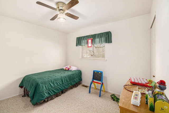 carpeted bedroom featuring ceiling fan and baseboards