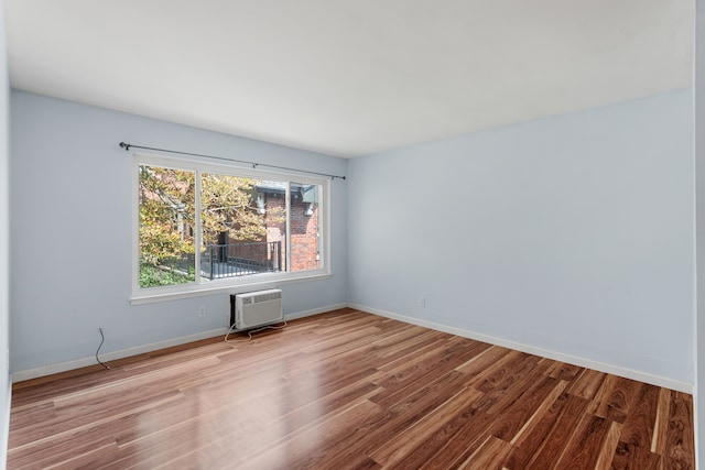 640 Virginia Park St, Detroit, MI 48202 - spare room featuring baseboards, wood finished floors, and a wall mounted AC
