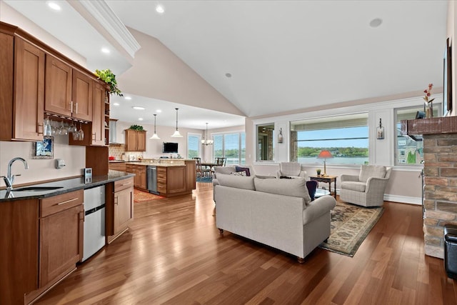 8427 Boulder Shores Dr, South Lyon, MI 48178 - living area with wood finished floors, recessed lighting, and high vaulted ceiling