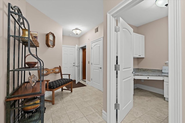 8427 Boulder Shores Dr, South Lyon, MI 48178 - hallway with an office area and baseboards