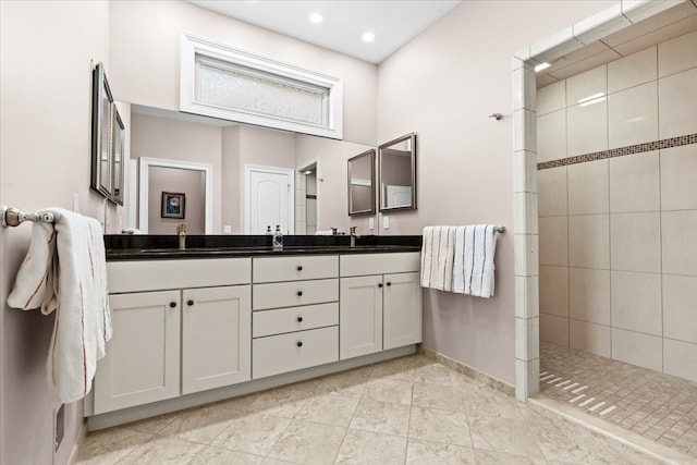 8427 Boulder Shores Dr, South Lyon, MI 48178 - bathroom featuring a walk in shower, baseboards, double vanity, and recessed lighting