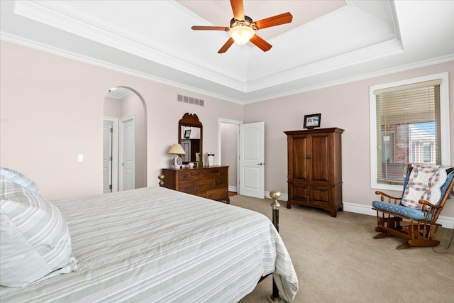 8427 Boulder Shores Dr, South Lyon, MI 48178 - bedroom featuring light colored carpet, a raised ceiling, arched walkways, crown molding, and baseboards