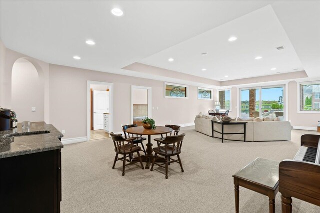 8427 Boulder Shores Dr, South Lyon, MI 48178 - dining room with a tray ceiling, light carpet, baseboards, and recessed lighting