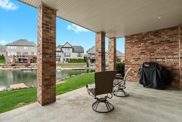 8427 Boulder Shores Dr, South Lyon, MI 48178 - view of patio / terrace featuring a water view, a residential view, and grilling area