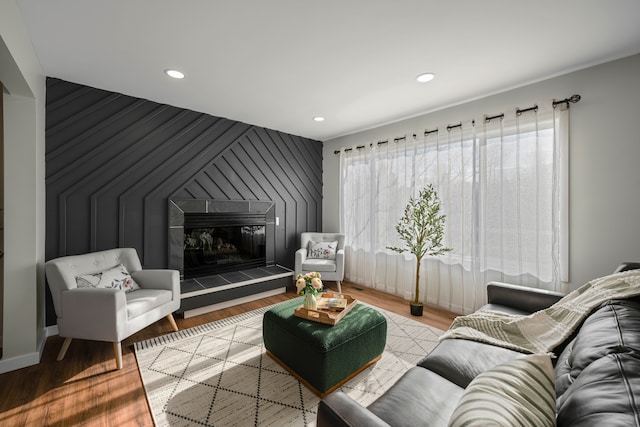 1525 Hiller Rd, West Bloomfield, MI 48324 - living room with an accent wall, wood finished floors, baseboards, recessed lighting, and a tiled fireplace