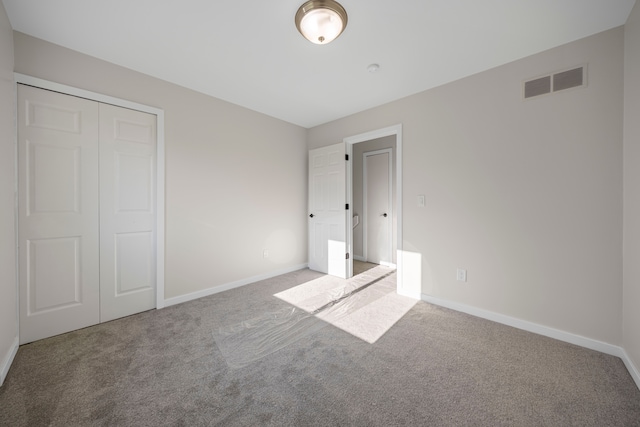 1525 Hiller Rd, West Bloomfield, MI 48324 - unfurnished bedroom featuring visible vents, baseboards, carpet floors, and a closet