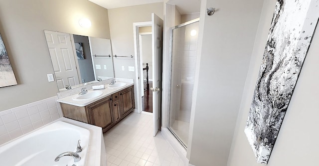 full bath featuring a stall shower, a garden tub, double vanity, and a sink