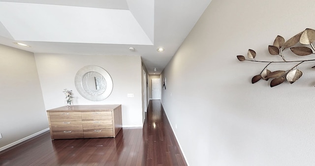 hall with baseboards, recessed lighting, and dark wood finished floors