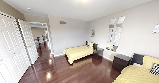 bedroom featuring baseboards, visible vents, and hardwood / wood-style flooring