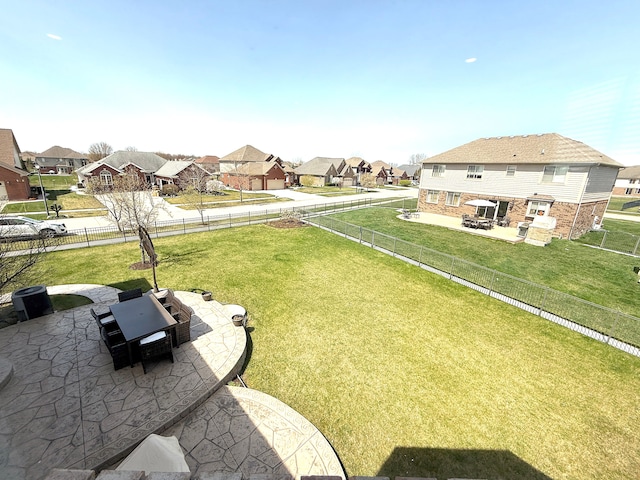view of yard featuring a residential view, a fenced backyard, and a patio area