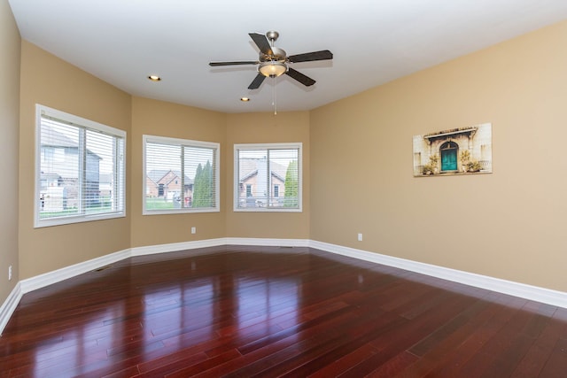 empty room with baseboards, recessed lighting, ceiling fan, and dark wood-type flooring