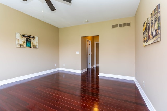 unfurnished room with baseboards, a ceiling fan, visible vents, and hardwood / wood-style flooring