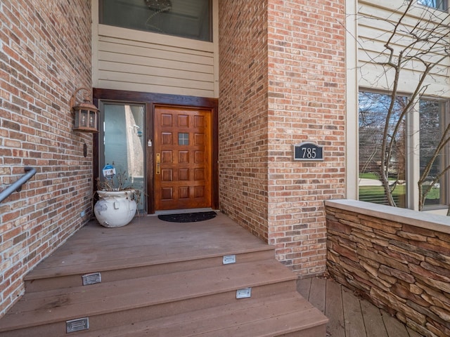 doorway to property featuring brick siding