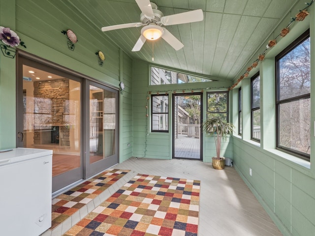 unfurnished sunroom with ceiling fan