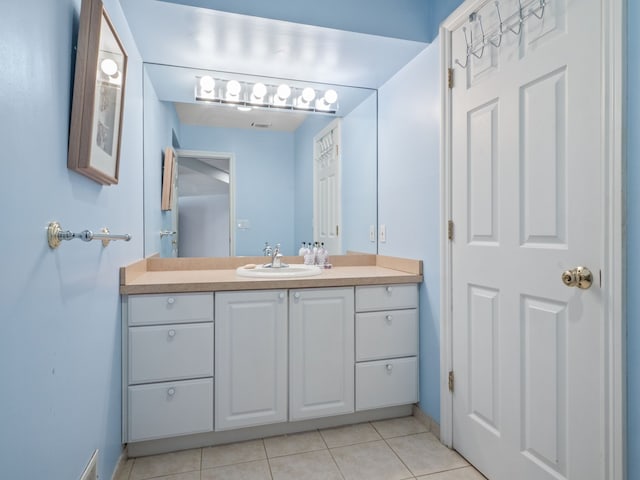 bathroom featuring baseboards, vanity, and tile patterned flooring