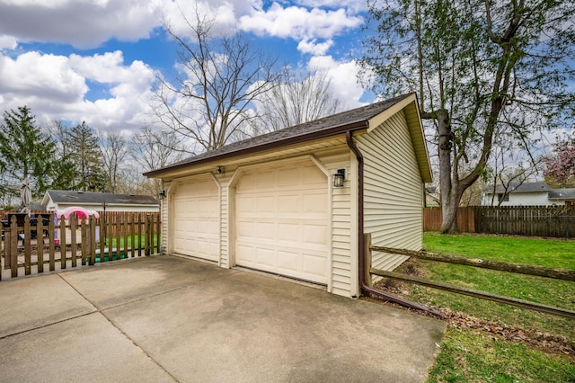 detached garage featuring fence