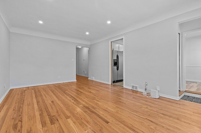 interior space featuring recessed lighting, baseboards, visible vents, and light wood finished floors