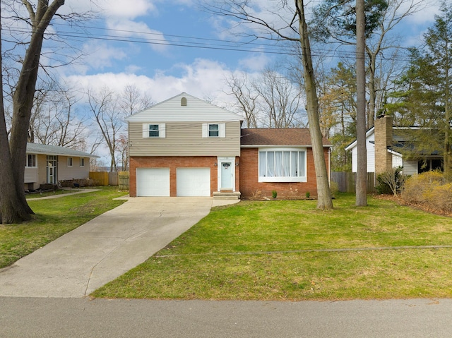 135 California Ave, Muskegon, MI 49445 - tri-level home featuring a front lawn, driveway, fence, brick siding, and an attached garage