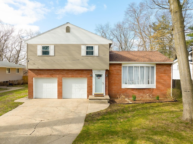 135 California Ave, Muskegon, MI 49445 - tri-level home with brick siding, a front yard, a garage, and concrete driveway