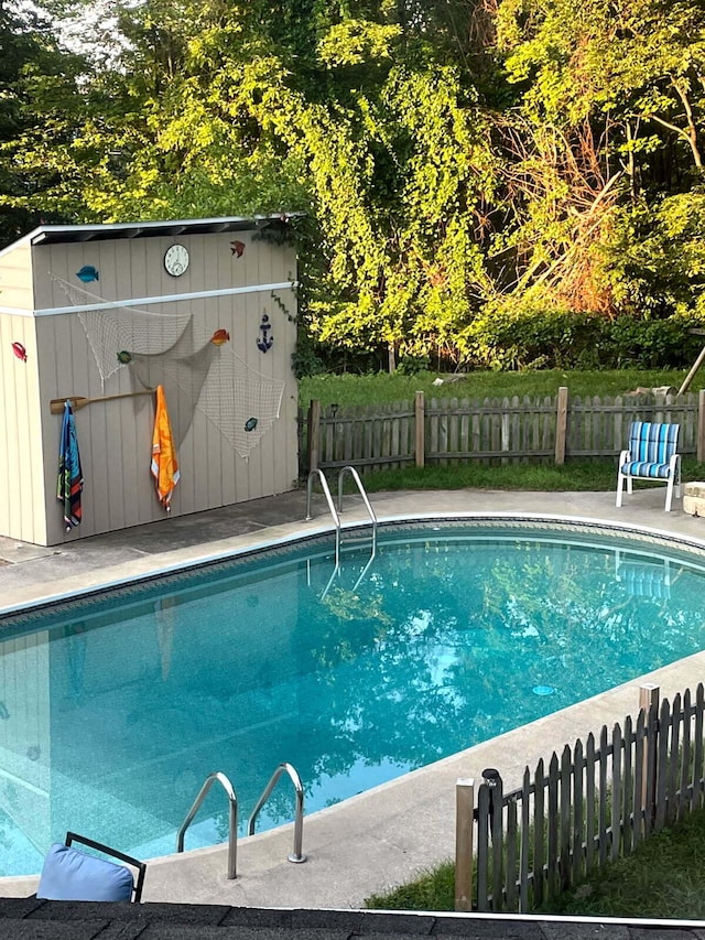 135 California Ave, Muskegon, MI 49445 - view of pool with fence, a fenced in pool, an outdoor structure, and a storage unit