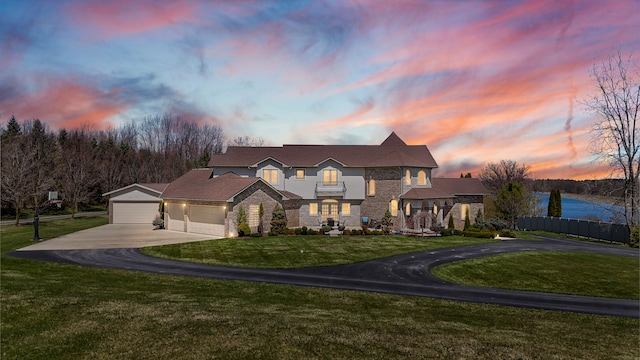 7455 Groveland Rd, Holly, MI 48442 - traditional-style house featuring a lawn, driveway, stone siding, an attached garage, and fence