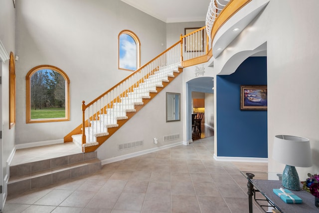 7455 Groveland Rd, Holly, MI 48442 - staircase featuring baseboards, visible vents, and a high ceiling