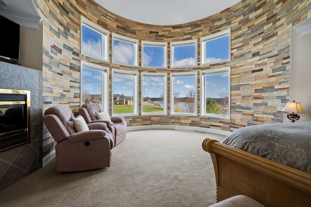 7455 Groveland Rd, Holly, MI 48442 - carpeted bedroom featuring a high ceiling, ornamental molding, and a multi sided fireplace