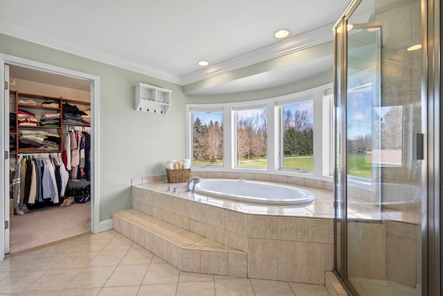 7455 Groveland Rd, Holly, MI 48442 - bathroom featuring tile patterned floors, a stall shower, a spacious closet, a garden tub, and ornamental molding