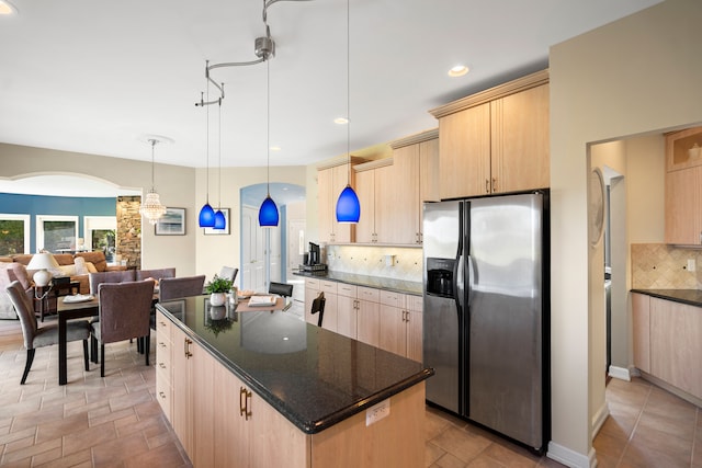 7455 Groveland Rd, Holly, MI 48442 - kitchen featuring arched walkways, light brown cabinets, stainless steel refrigerator with ice dispenser, and decorative backsplash