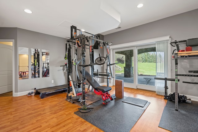 7455 Groveland Rd, Holly, MI 48442 - exercise room featuring baseboards, wood finished floors, and recessed lighting
