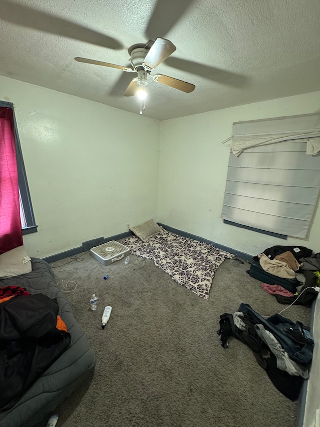 unfurnished bedroom with carpet, a ceiling fan, and a textured ceiling