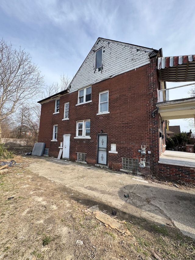 view of side of property with brick siding