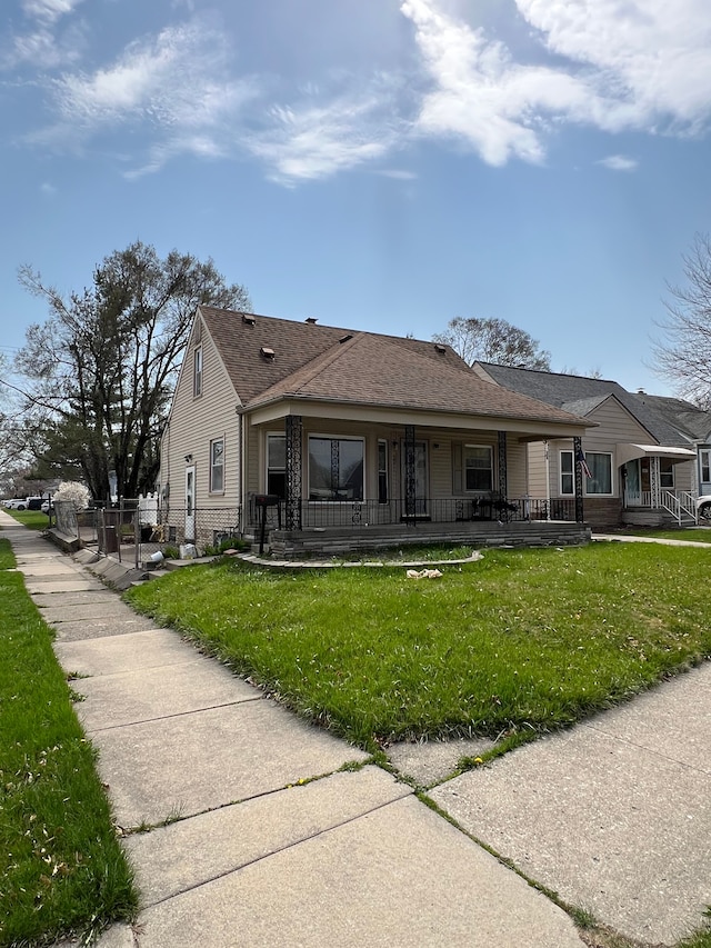 2011 Goddard Rd, Lincoln Park, MI 48146 - view of front of property featuring a porch, a front lawn, and fence