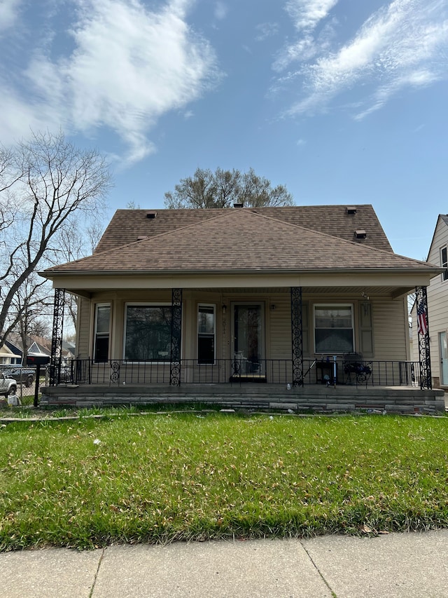 2011 Goddard Rd, Lincoln Park, MI 48146 - rear view of property featuring a lawn, a shingled roof, and covered porch
