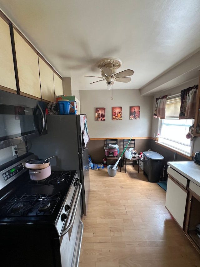 2011 Goddard Rd, Lincoln Park, MI 48146 - kitchen featuring stainless steel gas range, a ceiling fan, and light wood-style floors
