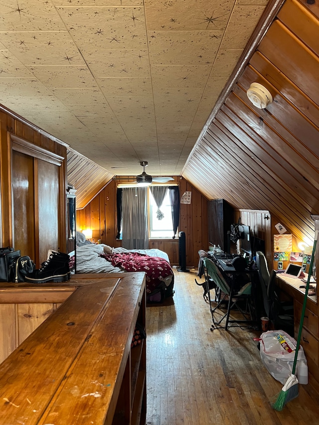 2011 Goddard Rd, Lincoln Park, MI 48146 - bedroom with vaulted ceiling, wood walls, and hardwood / wood-style flooring