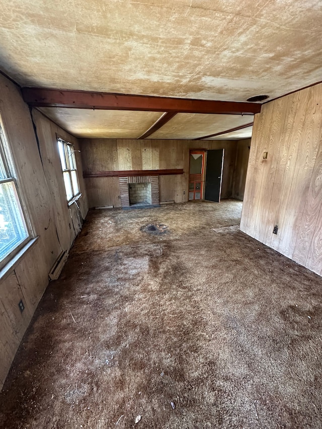 unfurnished living room featuring wooden walls