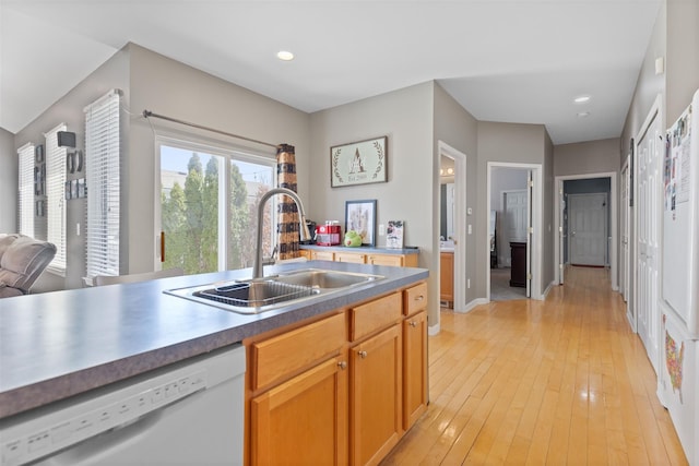kitchen featuring recessed lighting, white dishwasher, a sink, and light wood-style flooring